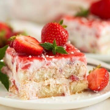 strawberry tiramisu piece topped with fresh strawberries.