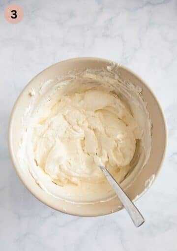 folding whipped cream into mascarpone and quark mixture for making tiramisu.