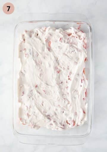 adding strawberry quark and mascarpone filling to tiramisu.