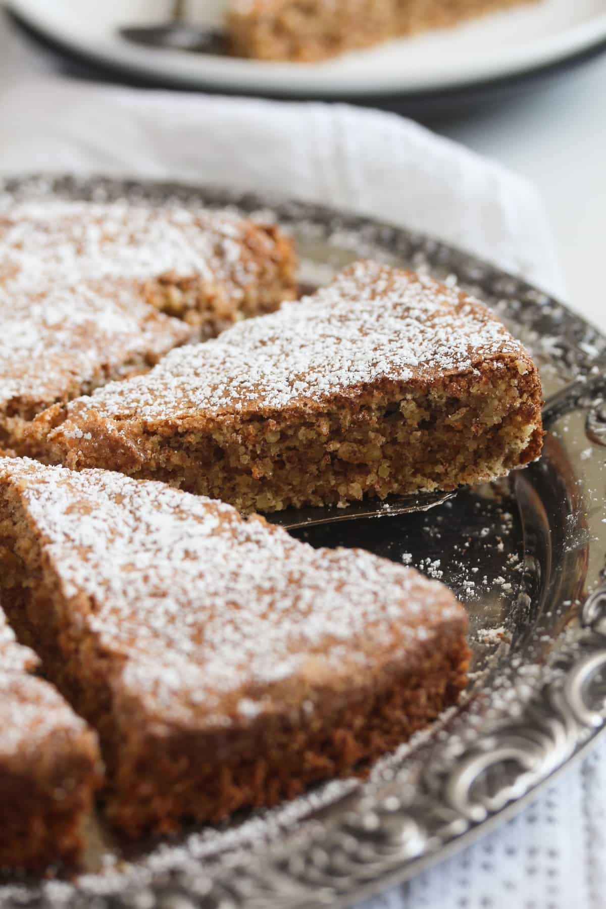 sliced tonka bean cake on a vintage serving plate.