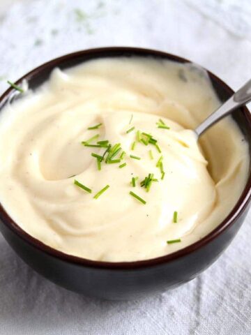 little bowl with creamy mayo on the table.