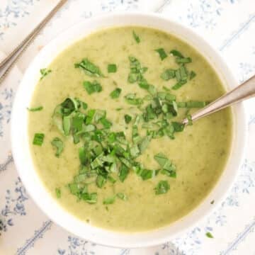 wild garlic and potato soup sprinkled with chopped wild garlic leaves in a bowl.