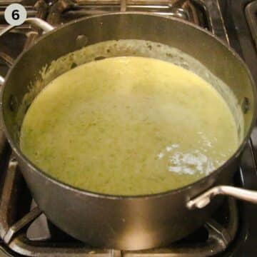 blended soup with potatoes and wild garlic in a pot on the stove.