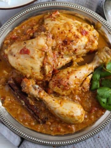 indian balti chicken with sauce and fresh cilantro in a small bowl.