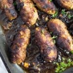 thick and short cevapcici sausage sprinkled with parsley in a grill pan.