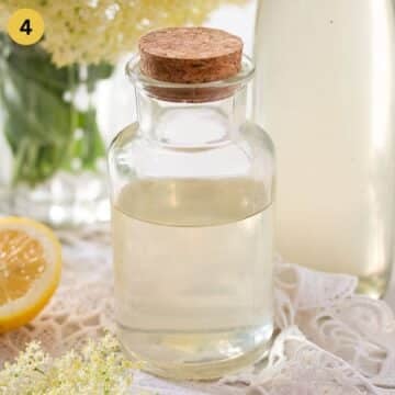 bottled elderflower syrup in a small bottle.