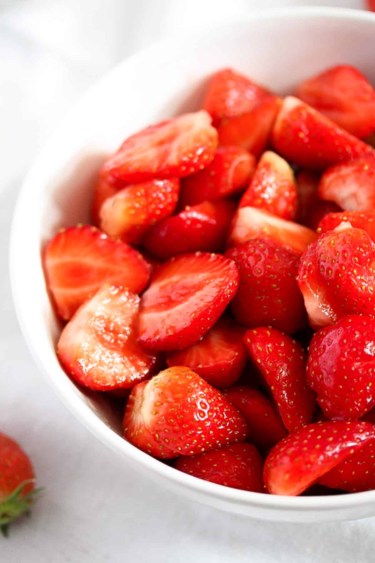 chopped strawberries macerating in a bowl.