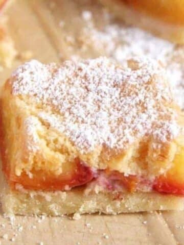 one square piece of nectarine cake dusted with powdered sugar.