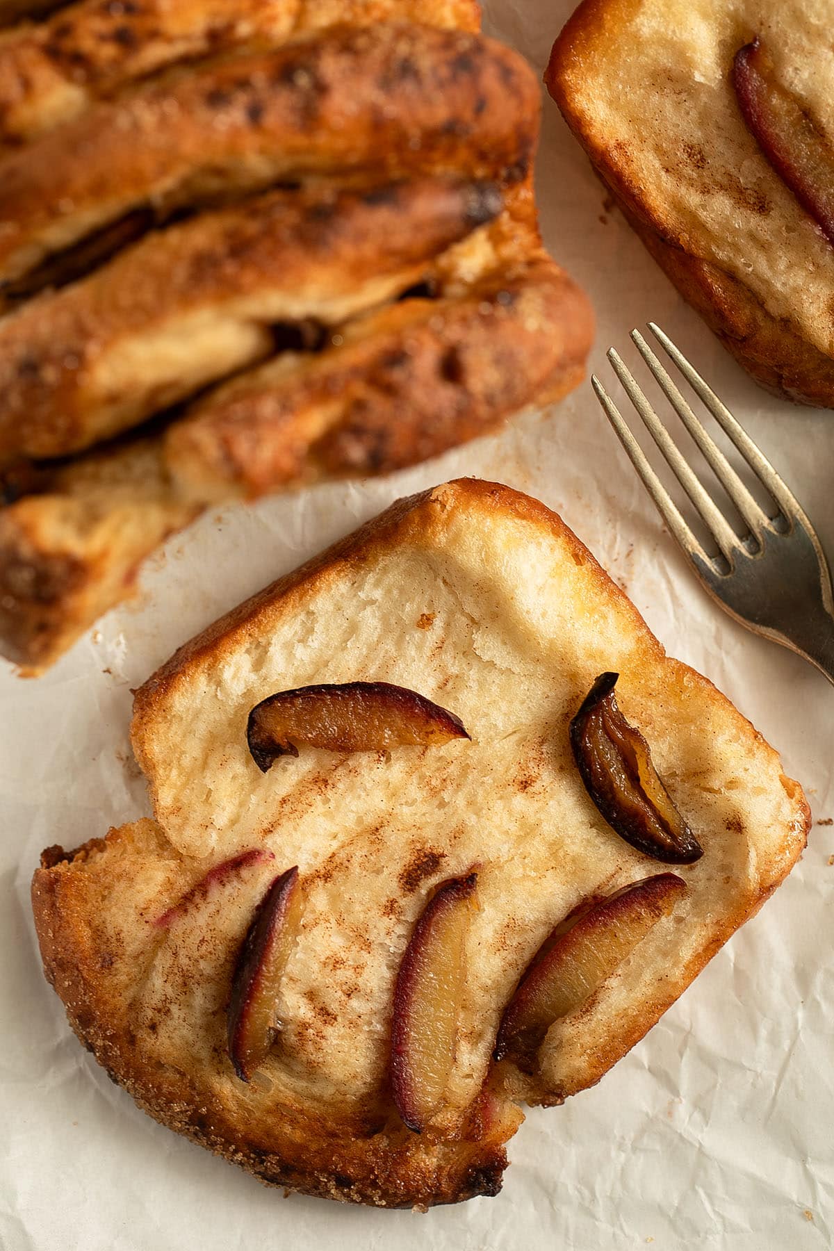 one large slice of fluffy plum bread with fruit slices on top.
