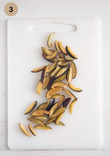 thinly sliced plums for making plum bread.