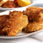 several pieces of cripsy fried potato crusted chicken on a platter.