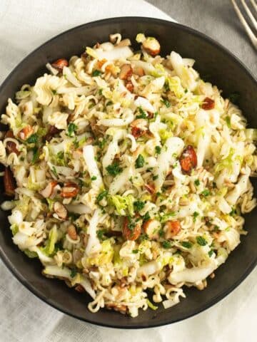 a bowl full of ramen napa cabbage salad in a bowl.