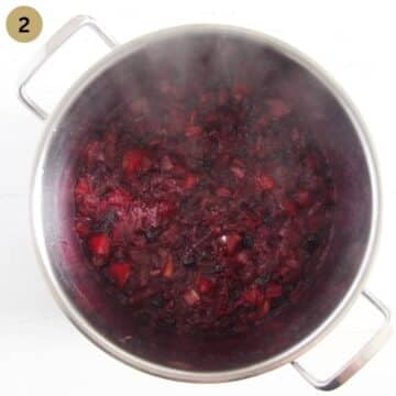 cooking rhubarb and blueberry jam in a large jam.