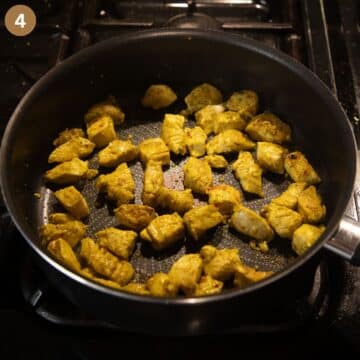 cooking marinated chicken cubes in a saucepan.