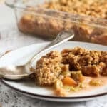 apple rhubarb crisp served on a small white vintage plate.