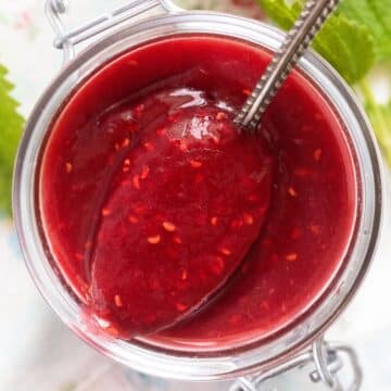 close up of rhubarb raspberry jam spooned from a jar.