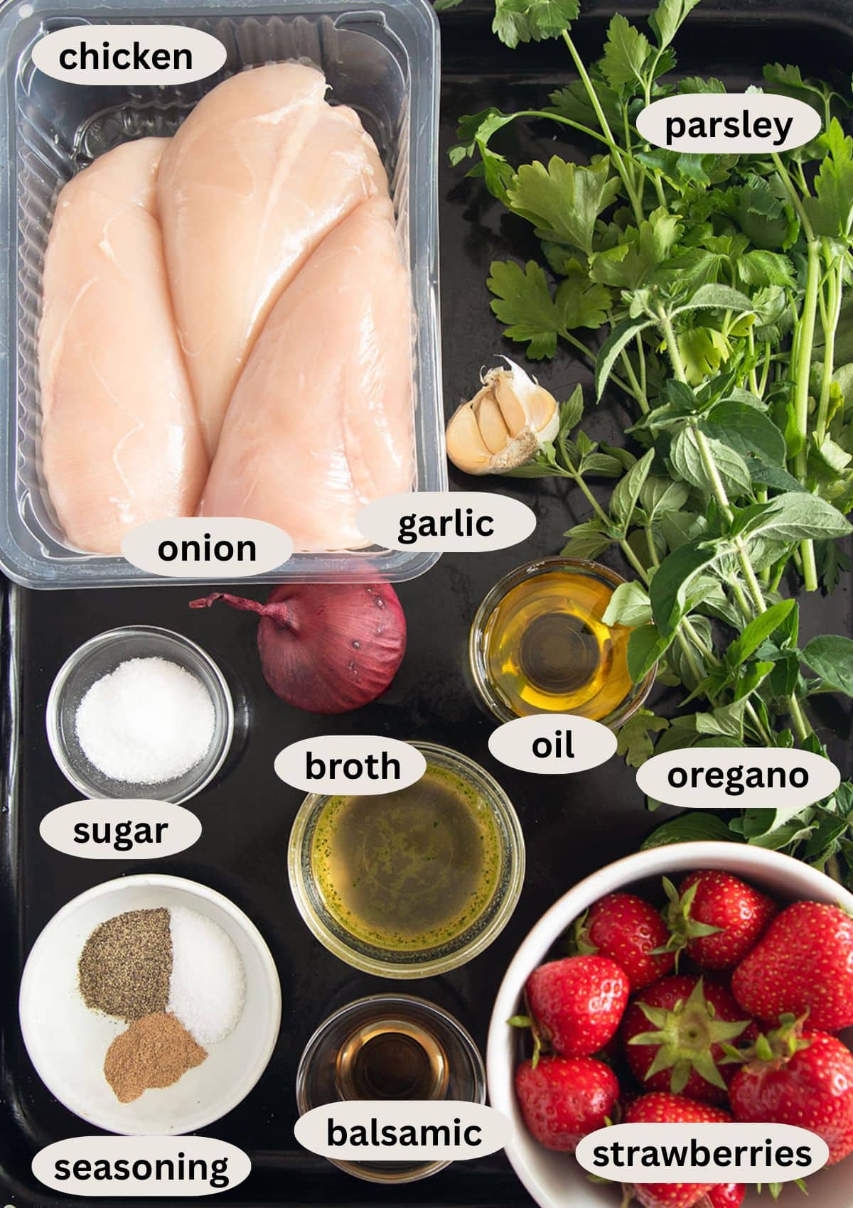 labeled ingredients for making savory strawberry chicken with herbs.