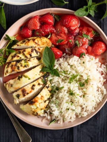 savory strawberry chicken served with rice on a plate.