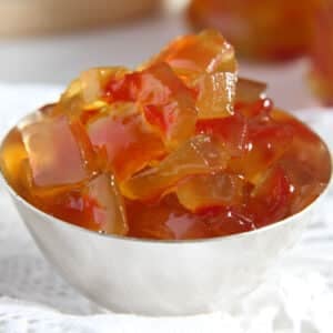 watermelon rind jam pieces in a small cup.