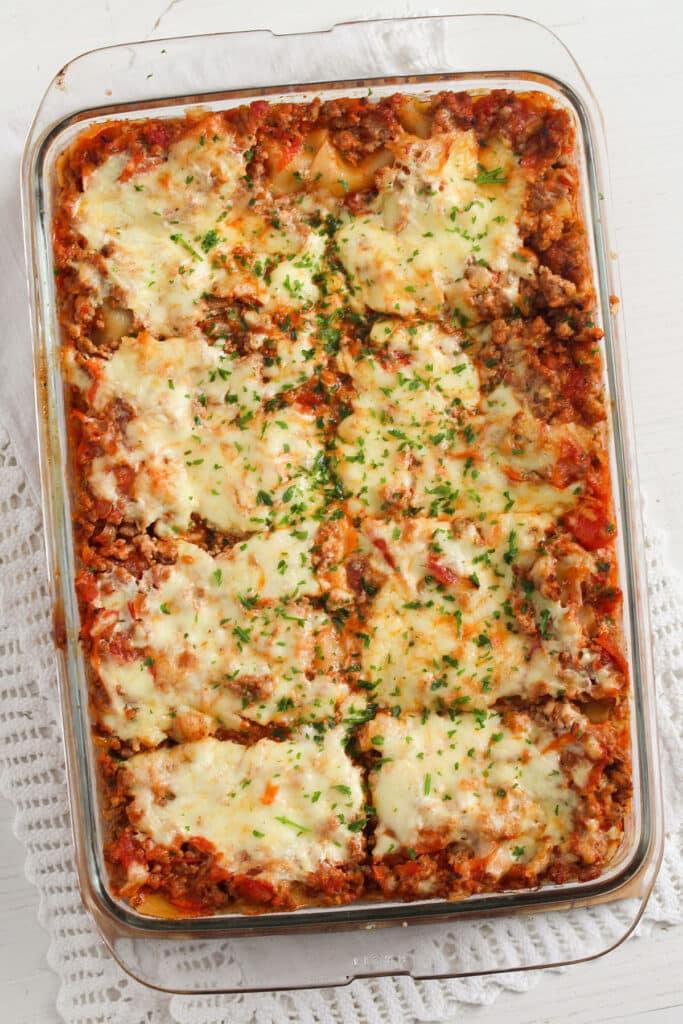 large baking dish with greek yogurt lasagna with meat sauce cut into eight squares.
