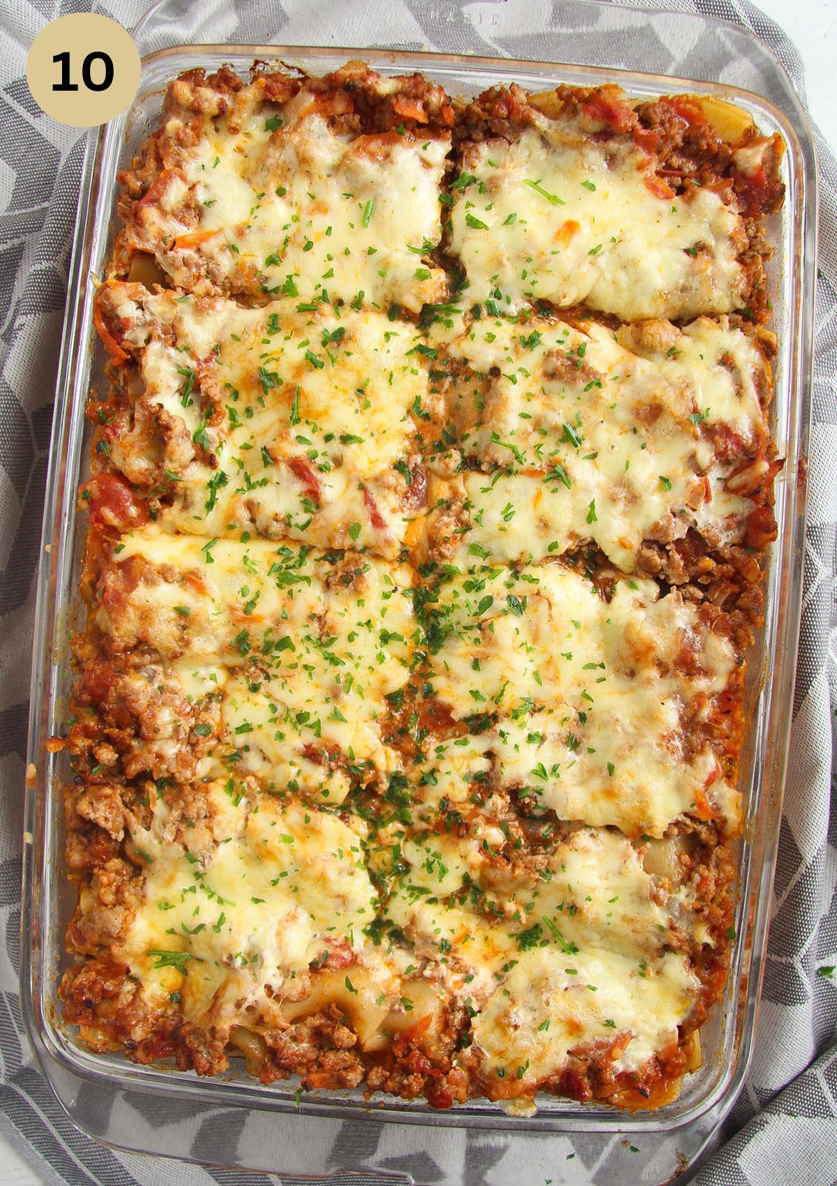 baked yogurt lasagna sprinkled with parsley in the baking dish.