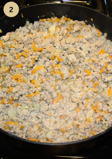 browning ground beef and carrots in a pan.