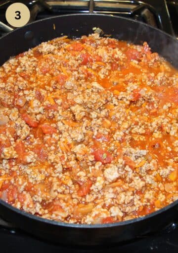 meat sauce for lasagna cooking in a pan.