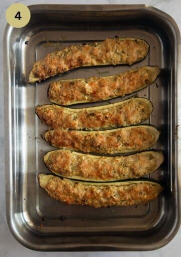 stuffed zucchini with cottage cheese and millet in a roasting pan.