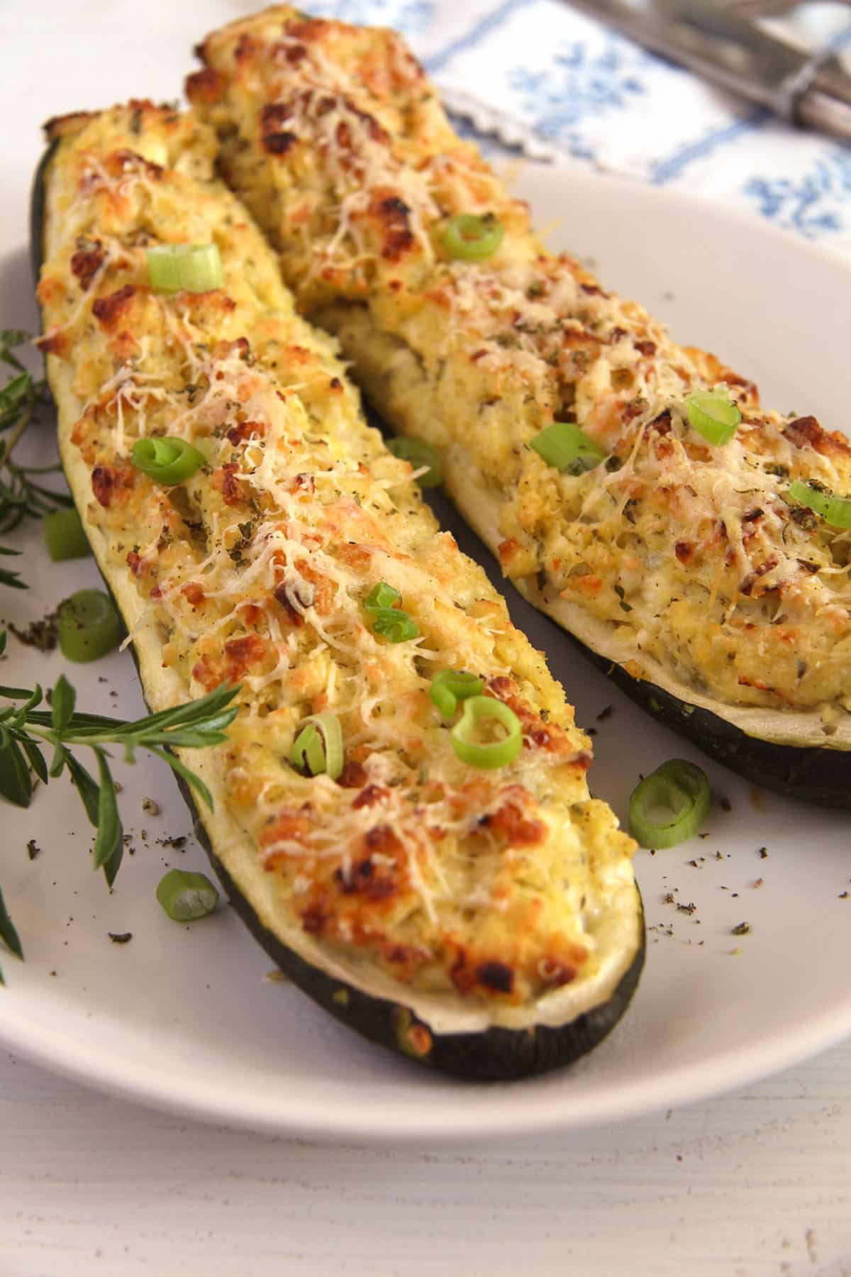 zucchini and cottage cheese boats and fresh thyme on a plate. 