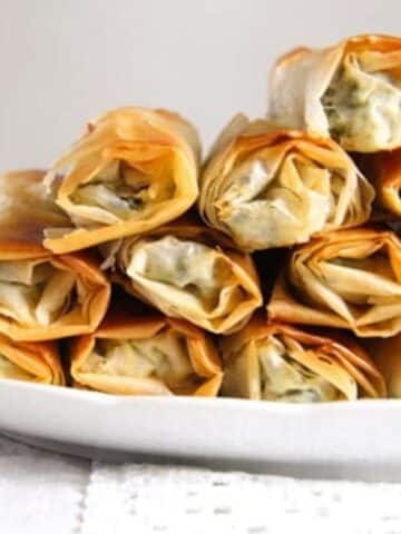 albanian spinach rolls with feta stapled on a plate.