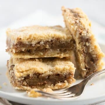 three pieces of apple hazelnut cake on a plate with a fork.