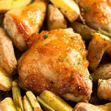 baked mango chicken thigh baked with potatoes and green onions.