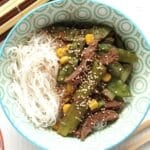 bowl with beef, ginger, spring onions and asian noodles.