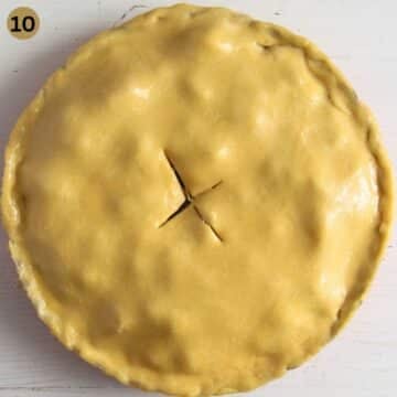 an unbaked pie with double brust brushed with egg wash.