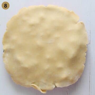 covering a pie with a second sheet of dough.