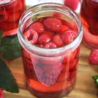 open jar of canned raspberries