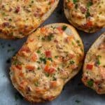 cheese topped rolls with ham, peppers and parsley.