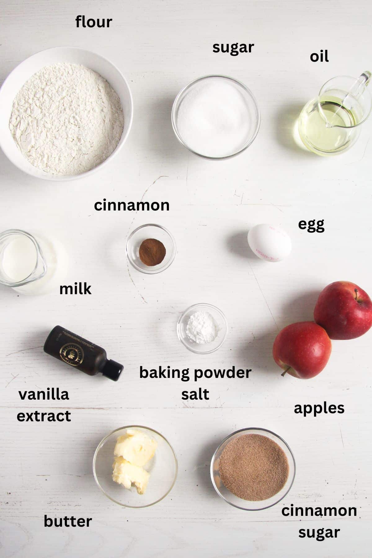 listed ingredients for making donut muffins with cinnamon and apples.