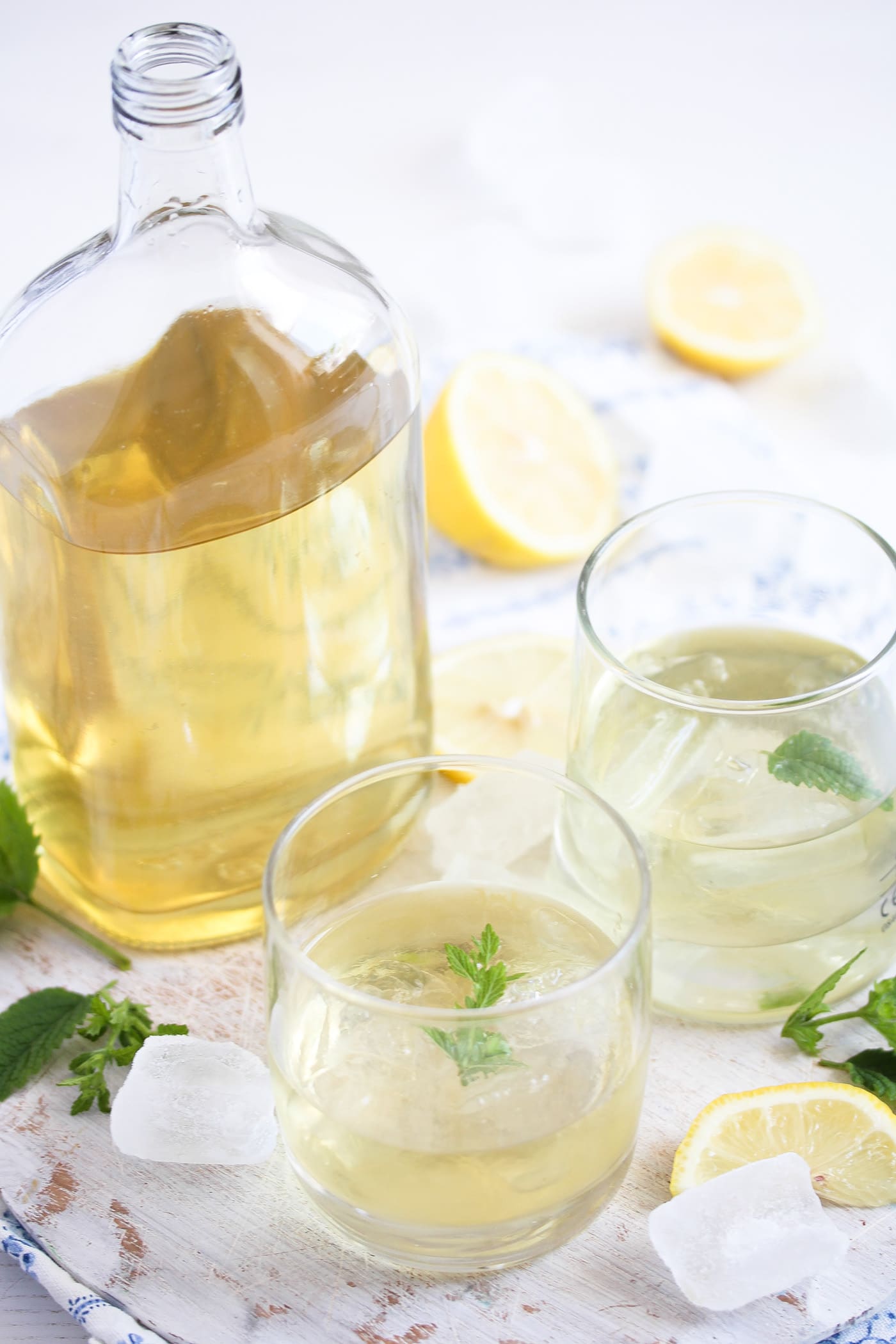 bottle with yellow liquor and a glass with ice