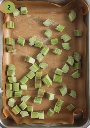 frozen rhubarb pieces in a roasting tin lined with parchment paper.