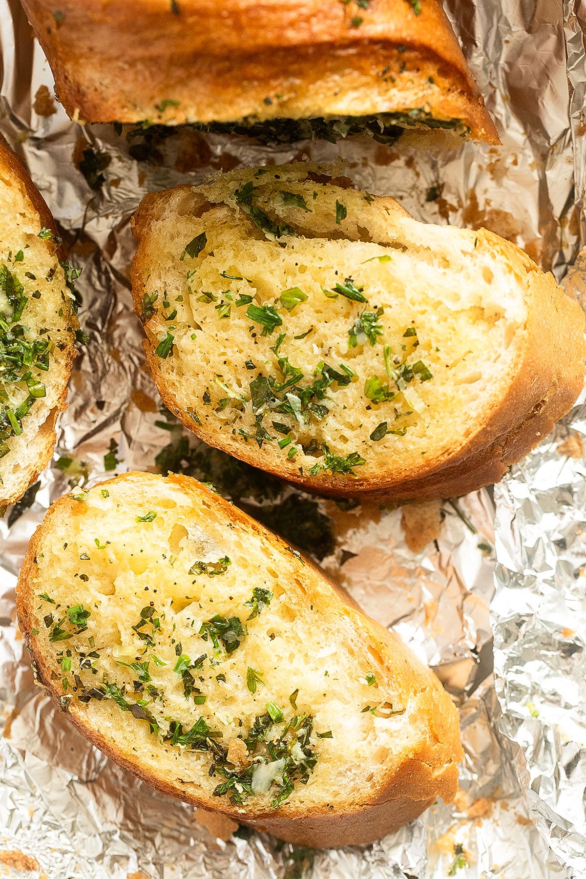 two slices of garlic bread with herbs. 
