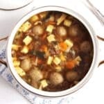 beef and dumpling soup in a large vintage bowl.