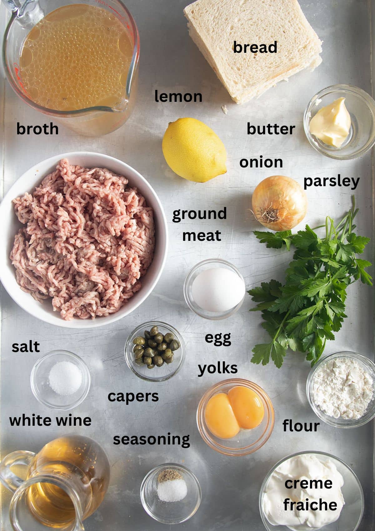 labeled ingredients for making german meatballs in white caper sauce.