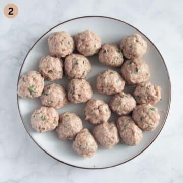 uncooked meatballs or königsberg klopse on a plate.