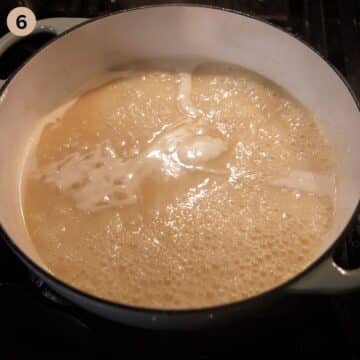 simmering white sauce for german meatballs with capers.