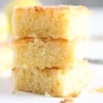 three pieces of lemon drizzle traybake cake stapled on each other.