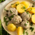 german meatballs with white sauce with capers and potatoes.