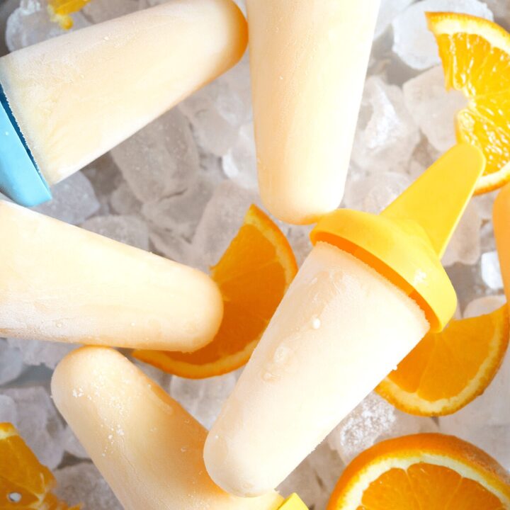 orange popsicles on a bed of ice cubes