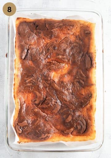 baked brownies with cream cheese in a baking dish made of glass.