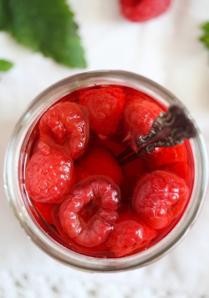 jar of red raspberries seen from above